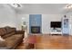 Cozy living room features hardwood floors, a fireplace, and access to other rooms at 312 Flat Shoals Church Rd, Stockbridge, GA 30281