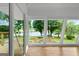 A sunroom with walls of windows looking out over a lake and landscaped yard at 312 Flat Shoals Church Rd, Stockbridge, GA 30281