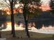 Beautiful sunset over the lake, showcasing tranquil scenery with a dock for evening relaxation at 312 Flat Shoals Church Rd, Stockbridge, GA 30281