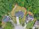 A beautiful aerial view shows the home with dark gray shingles and a driveway with a charming landscaped yard at 5409 Trumpet Vine Se Trl, Mableton, GA 30126