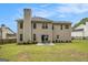 Exterior view of the back of the house and a large, well-maintained backyard with mature trees at 5409 Trumpet Vine Se Trl, Mableton, GA 30126