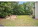 Expansive backyard with lush grass, mature trees, and a patio area for outdoor enjoyment at 5409 Trumpet Vine Se Trl, Mableton, GA 30126