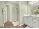 Well-lit bathroom showcasing vanity, tiled floors, and glass-enclosed shower at 5409 Trumpet Vine Se Trl, Mableton, GA 30126