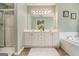 Bright bathroom featuring double vanity, soaking tub, and separate glass shower at 5409 Trumpet Vine Se Trl, Mableton, GA 30126