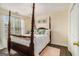 Comfortable bedroom with a four poster bed and soft natural light from the windows at 5409 Trumpet Vine Se Trl, Mableton, GA 30126