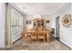 Formal dining room with wood table and chairs, plush rug, and natural light from large windows at 5409 Trumpet Vine Se Trl, Mableton, GA 30126