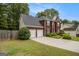 Charming brick front home with a two-car garage, lush lawn and mature landscaping at 5409 Trumpet Vine Se Trl, Mableton, GA 30126