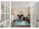 Bright home office featuring white shelving, a modern workstation, and a comfortable seating area at 5409 Trumpet Vine Se Trl, Mableton, GA 30126