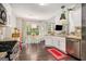 Bright kitchen with stainless appliances, open layout, and adjacent dining area with backyard views at 5409 Trumpet Vine Se Trl, Mableton, GA 30126