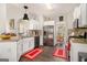 Modern kitchen with stainless steel appliances, custom backsplash, and bright white cabinetry at 5409 Trumpet Vine Se Trl, Mableton, GA 30126