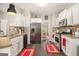 Well-lit kitchen with stainless steel appliances, designer backsplash and dark hardwood floors at 5409 Trumpet Vine Se Trl, Mableton, GA 30126