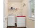 Laundry room with washer, dryer, shelving, and natural light from the window at 5409 Trumpet Vine Se Trl, Mableton, GA 30126