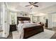 Large bedroom with tray ceilings, ceiling fan and adjacent sitting room at 5409 Trumpet Vine Se Trl, Mableton, GA 30126