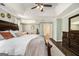Main bedroom featuring tray ceiling, ceiling fan, and hardwood floors at 5409 Trumpet Vine Se Trl, Mableton, GA 30126