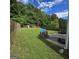 Large backyard with playhouse, trampoline, swing set, and ample green space for outdoor activities at 590 Dot Dr, Atlanta, GA 30349