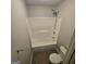 Bright bathroom with a white tub-shower combo, chrome fixtures, and neutral-toned tile flooring at 590 Dot Dr, Atlanta, GA 30349