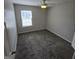 Bright bedroom featuring a ceiling fan and a large window at 590 Dot Dr, Atlanta, GA 30349