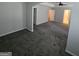 Large bedroom boasts modern gray walls, plush carpeting, and an arched doorway for a cozy and stylish feel at 590 Dot Dr, Atlanta, GA 30349