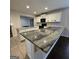 Modern kitchen with granite countertops, white cabinets, and stainless steel appliances at 590 Dot Dr, Atlanta, GA 30349