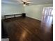 Open living room featuring hardwood floors, a ceiling fan, and seamless flow into other areas at 590 Dot Dr, Atlanta, GA 30349