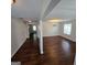 Open-concept living space with hardwood floors, neutral paint and stylish light fixtures at 590 Dot Dr, Atlanta, GA 30349
