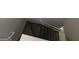 Carpeted stairs feature a white banister and lead to the upper level of the home at 590 Dot Dr, Atlanta, GA 30349