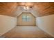 Finished attic with a wood ceiling, dormer windows, and neutral carpeting at 145 County Line Ct, Fayetteville, GA 30215