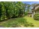 Green backyard featuring a sunroom and lots of shade trees at 145 County Line Ct, Fayetteville, GA 30215