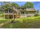 Expansive backyard featuring a raised deck and mature trees, offering privacy and outdoor living space at 145 County Line Ct, Fayetteville, GA 30215