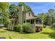 The exterior of this home features a screened in porch and large chimney in a tree-filled backyard at 145 County Line Ct, Fayetteville, GA 30215
