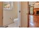 Cozy bathroom featuring a toilet, window, and neutral tones providing a clean and functional space at 145 County Line Ct, Fayetteville, GA 30215
