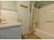 Well-lit bathroom featuring a shower-tub combination, a single sink vanity, and tiled floors at 145 County Line Ct, Fayetteville, GA 30215