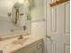 Bathroom featuring a round mirror, white vanity, and decorative white beadboard walls at 145 County Line Ct, Fayetteville, GA 30215