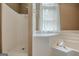 An angled whirlpool tub is adjacent to a shower at 145 County Line Ct, Fayetteville, GA 30215