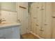 Nautical-themed bathroom with a large single vanity and a white beadboard accent wall at 145 County Line Ct, Fayetteville, GA 30215