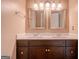 A bathroom featuring a double vanity with a framed mirror and hardware at 145 County Line Ct, Fayetteville, GA 30215