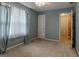Bedroom featuring a fan, beige carpet, and a window with sheer light blue curtains at 145 County Line Ct, Fayetteville, GA 30215
