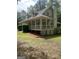 Side angle showing the home's screened in porch, dormer windows, and a charming columned porch at 145 County Line Ct, Fayetteville, GA 30215