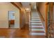 Elegant foyer featuring hardwood floors, a staircase, and views into other living spaces at 145 County Line Ct, Fayetteville, GA 30215