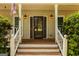 Inviting front entrance with a stained wood door, sidelights, and decorative lighting at 145 County Line Ct, Fayetteville, GA 30215