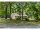 Traditional home nestled among trees, featuring a covered front porch at 145 County Line Ct, Fayetteville, GA 30215