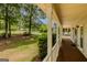 Spacious front porch with white columns, wood floors, and ample room for relaxing at 145 County Line Ct, Fayetteville, GA 30215