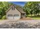 Attached two-car garage with a porch and a well-manicured lawn at 145 County Line Ct, Fayetteville, GA 30215