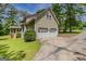 Attached two-car garage, rear sunroom, and driveway at 145 County Line Ct, Fayetteville, GA 30215