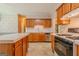 Well-maintained kitchen with wood cabinets, an island, and modern appliances for all culinary needs at 145 County Line Ct, Fayetteville, GA 30215
