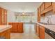 Traditional kitchen featuring wood cabinets, white countertops, an island, and a dining area, offering a cozy atmosphere at 145 County Line Ct, Fayetteville, GA 30215