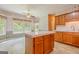 Charming kitchen featuring wood cabinets, an island, and a dining nook with lots of windows at 145 County Line Ct, Fayetteville, GA 30215