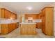 Spacious kitchen showcasing wood cabinets, an island, and ample countertop space, ideal for cooking and entertaining at 145 County Line Ct, Fayetteville, GA 30215