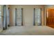 Open living room featuring carpet floors and multiple windows for natural light at 145 County Line Ct, Fayetteville, GA 30215