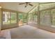 Relaxing sunroom with vaulted ceiling and large windows overlooking the backyard at 145 County Line Ct, Fayetteville, GA 30215